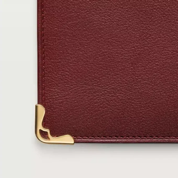 Internationale Geldbörse mit Seitenfalten, Must de Cartier – burgunderrotes Kalbsleder, goldfarbenes Finish – Cartier